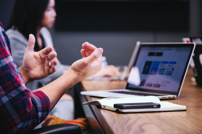 Professional discussing strategy with a colleague at a desk